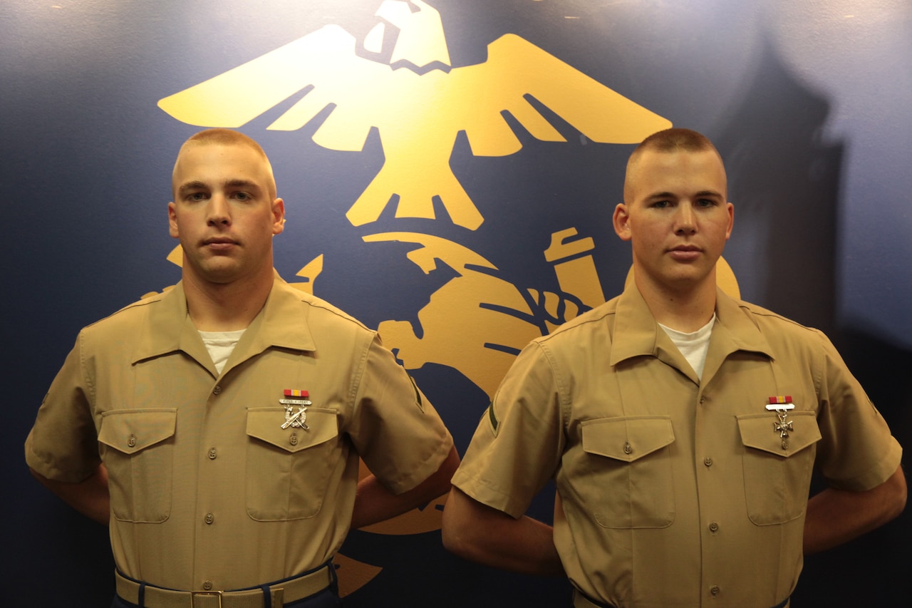 (Left) Pfc. Brandon Willibey, an aviation ordnance technician student and this brother Pfc. Justin Willibey, a military policeman student, Springville, N.Y., natives graduated from Recruit Training with Platoon 1077, Bravo Company, 1st Recruit Training Battalion, Sept. 18, 2015. Their boot camp photos rest on a Transformation Board in Marine Corps Recruiting Substation West Seneca’s office, serving as a reminder to all, that becoming a Marine changes the mind, body and spirit. (Official U.S. Marine Corps photo by Staff Sgt. Christopher O’Quin/Released)