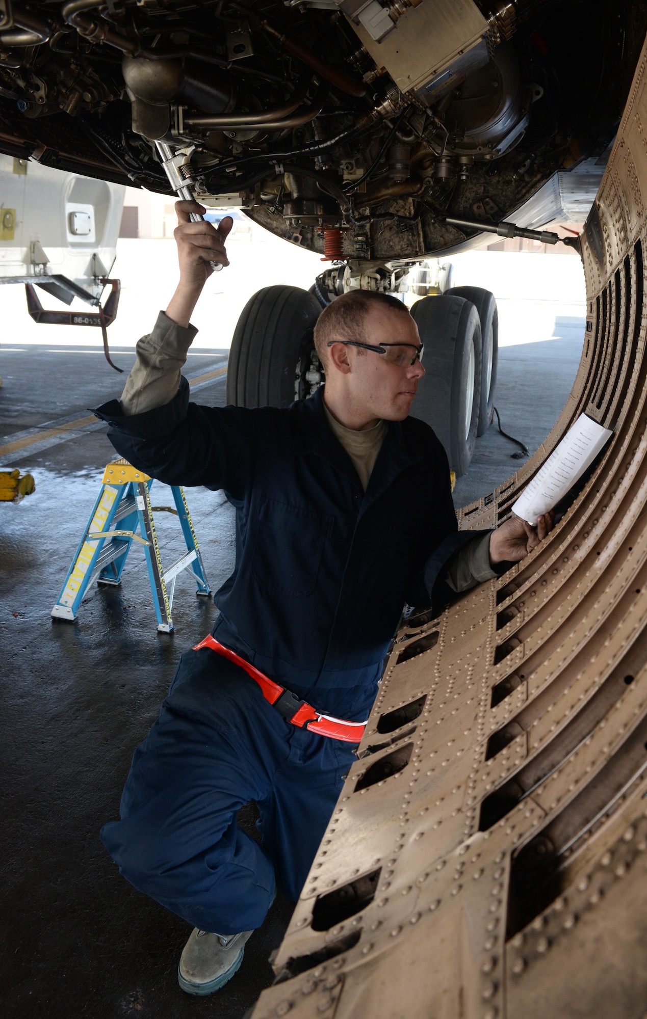 An Airman reads a checklist while performing maintenance on a B-1 bomber. Images were captured of Airmen reading around the base in recognition of National Read Across America Day, an observance in the United States celebrated on the school day closest to March 2, the birthday of Dr. Seuss. This day is a part of an overall Read Across America initiative, created by the National Education Association, dedicated to reading. (U.S. Air Force photo by Airman Donald Knecthel)