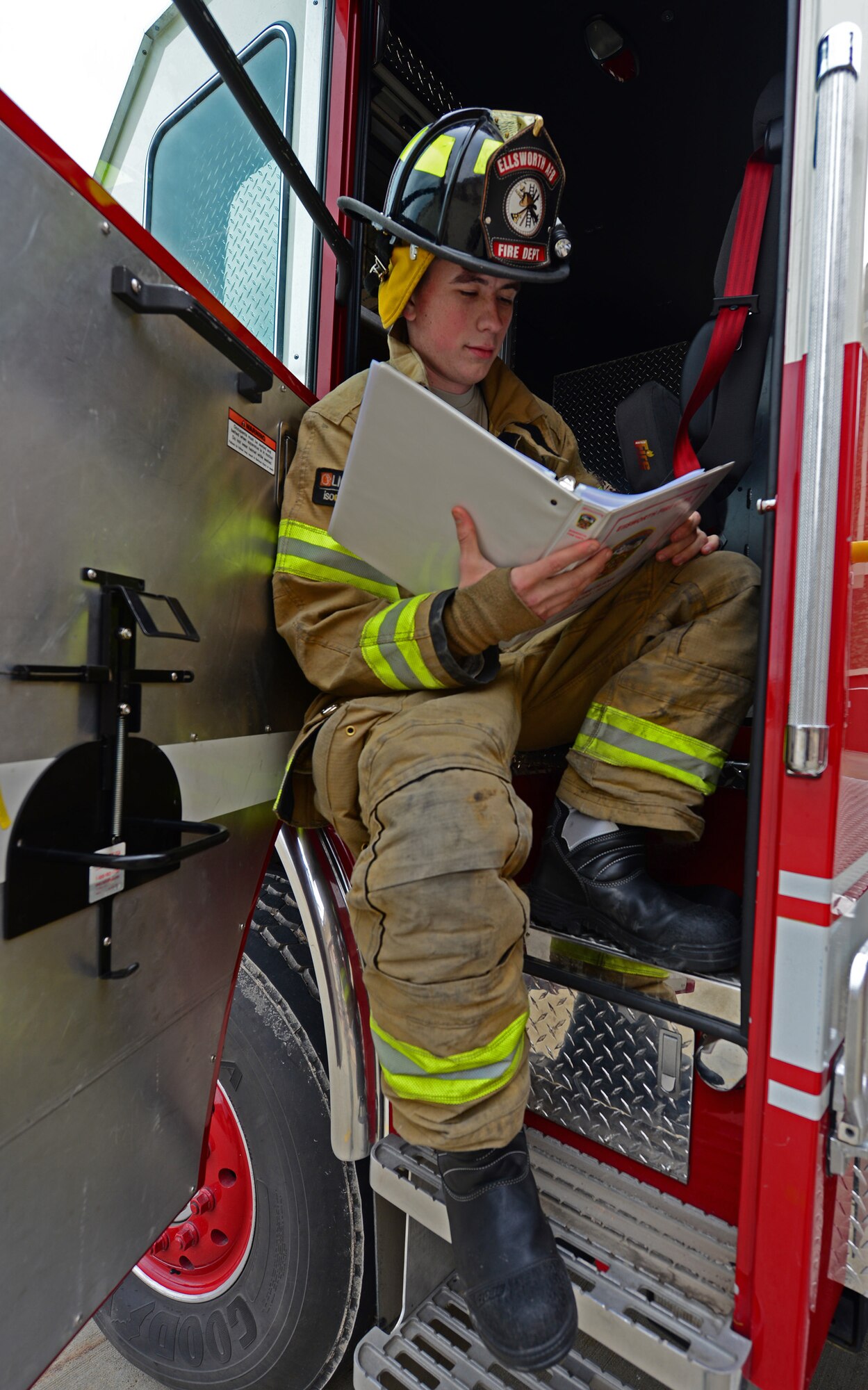 A firefighter from the 28th Civil Engineer Squadron reads a fire safety checklist. Images were captured of Airmen reading around the base in recognition of National Read Across America Day, an observance in the United States celebrated on the school day closest to March 2, the birthday of Dr. Seuss. This day is a part of an overall Read Across America initiative, created by the National Education Association, dedicated to reading. (U.S. Air Force photo by Airman 1st Class James Miller)