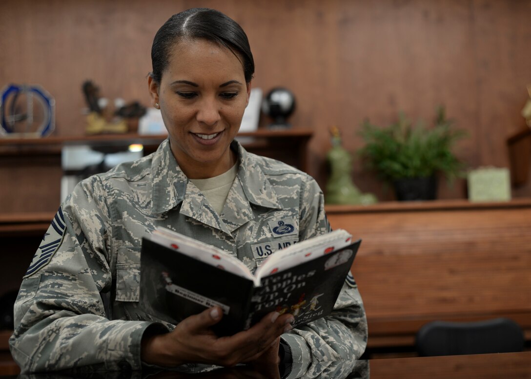 Chief Master Sgt. Sonia Lee, 28th Bomb Wing command chief, reads a book in her office. Images were captured of Airmen reading around the base in recognition of National Read Across America Day, an observance in the United States celebrated on the school day closest to March 2, the birthday of Dr. Seuss. This day is a part of an overall Read Across America initiative, created by the National Education Association, dedicated to reading. (U.S. Air Force photo by Senior Airman Anania Tekurio)
