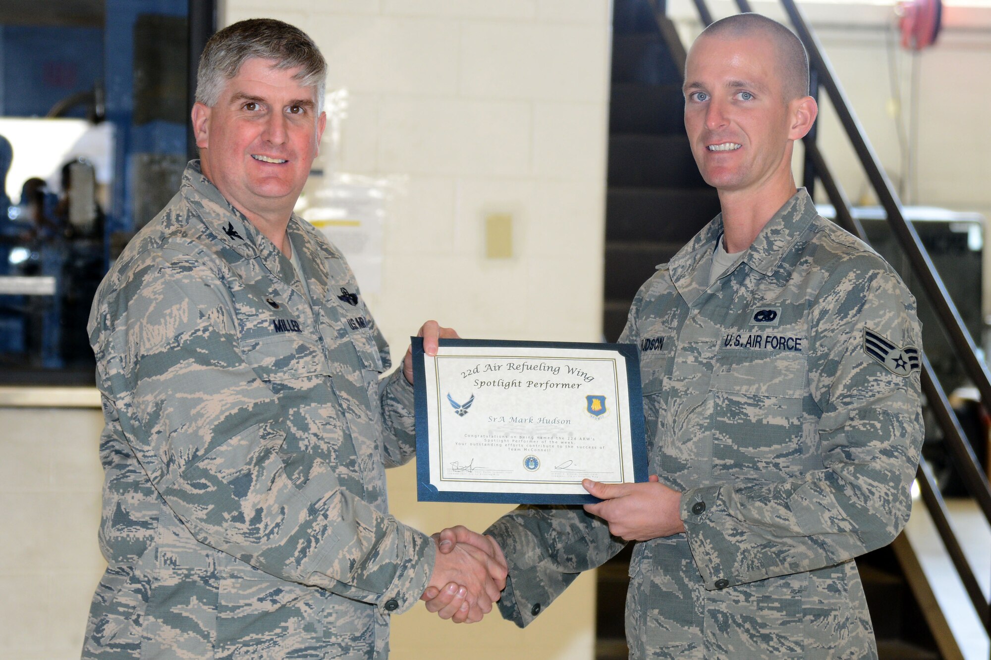 Senior Airman Mark Hudson, 22nd Maintenance Squadron aerospace ground equipment journeyman, poses with Col. Albert Miller, 22nd Air Refueling Wing commander, Feb. 29, 2016, at McConnell Air Force Base, Kan. Hudson received the spotlight performer for the week of Feb. 22 – 26. (U.S. Air Force photo/Airman 1st Class Christopher Thornbury)