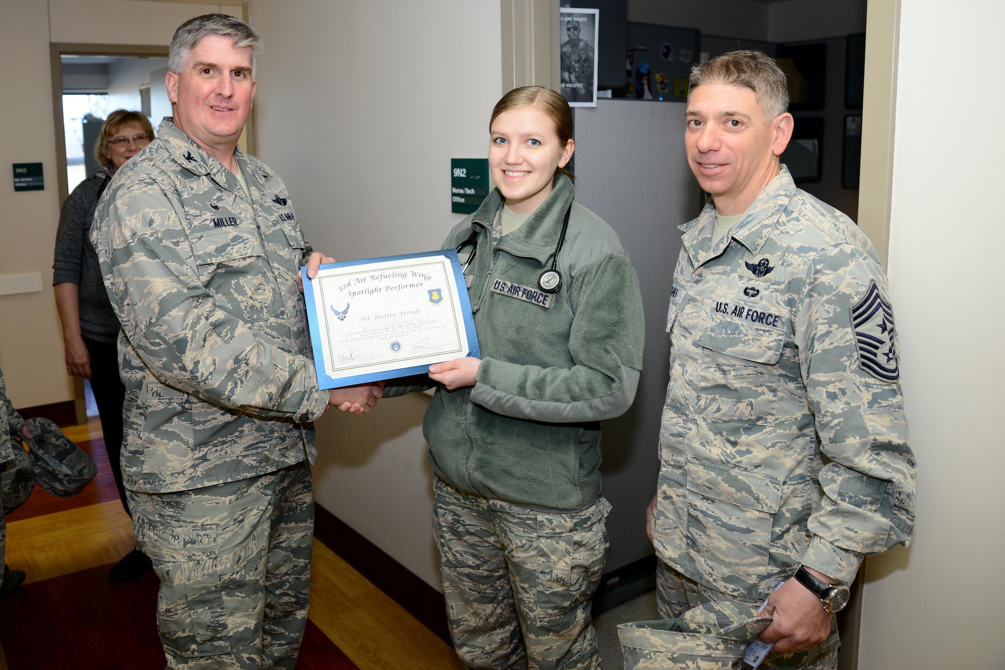 Airman 1st Class Justine Froude, 22nd Medical Operations Squadron family medical technician, poses with Col. Albert Miller, 22nd Air Refueling Wing commander, and Chief Master Sgt. Shawn Hughes, 22nd ARW command chief, Feb. 29, 2016, at McConnell Air Force Base, Kan. Froude received the spotlight performer for the week of Feb. 15 - 19. (U.S. Air Force photo/Airman 1st Class Christopher Thornbury)