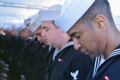 Sailors bow their heads in prayer during the graduation ceremony of Nuclear Power School class 1506 at Naval Nuclear Power Training Command (NNPTC) in Goose Creek, S.C. Based at Joint Base Charleston-Naval Weapons Station, NNPTC trains Sailors in fundamentals of design, operation, and maintenance of shipboard nuclear propulsion plants. (U.S. Navy Photo by Mass Communications Specialist Second Class Jason Pastrick)