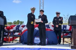 Machinist's Mate Third Class Michelle Brasfield recieves the Fleet Reserve Association's Hard Charger award during the graduation ceremony of Nuclear Power School class 1506 at Naval Nuclear Power Training Command (NNPTC) in Goose Creek, S.C. Based at Joint Base Charleston-Naval Weapons Station, NNPTC trains Sailors in fundamentals of design, operation, and maintenance of shipboard nuclear propulsion plants. (U.S. Navy photo by Mass Communication Specialist Second Class Corey Dill