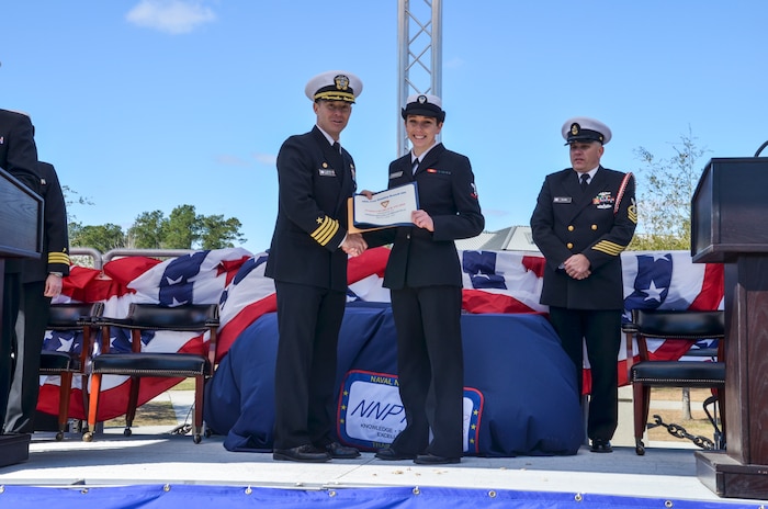 Machinist's Mate Third Class Michelle Brasfield recieves the Fleet Reserve Association's Hard Charger award during the graduation ceremony of Nuclear Power School class 1506 at Naval Nuclear Power Training Command (NNPTC) in Goose Creek, S.C. Based at Joint Base Charleston-Naval Weapons Station, NNPTC trains Sailors in fundamentals of design, operation, and maintenance of shipboard nuclear propulsion plants. (U.S. Navy photo by Mass Communication Specialist Second Class Corey Dill