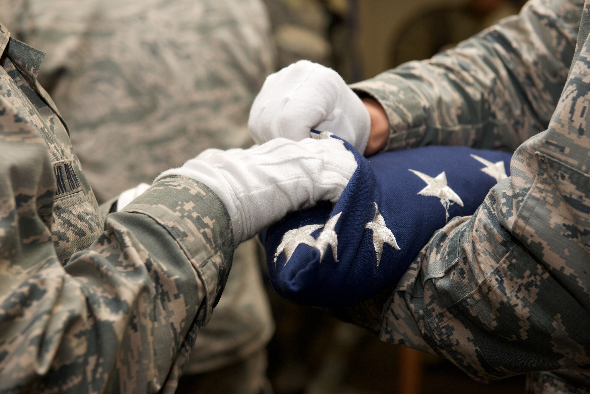 U.S. Air Force Ceremonial guardsmen practice the two-man flag fold at Langley Air Force Base, Va., Feb. 24. 2016. After the flag is completely folded, it takes on the appearance of a cocked hat, in remembrance to the Soldiers, Sailors and Marines who fought in the Revolution War. (U.S. Air Force photo by Airman 1st Class Derek Seifert/Released)