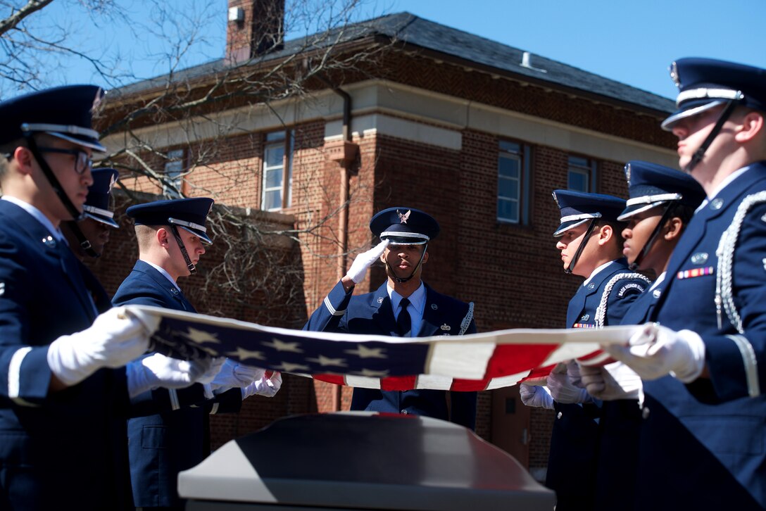 U.S. Air Force Staff Sgt. Quinton Gittens, Honor Guard noncommissioned officer in charge of training, salutes the flag before it’s folded at Langley Air Force Base, Va., Feb. 29, 2016. On the final day of training, the new ceremonial guardsmen perform a full 20-man funeral ceremony. (U.S. Air Force photo by Airman 1st Class Derek Seifert/Released)