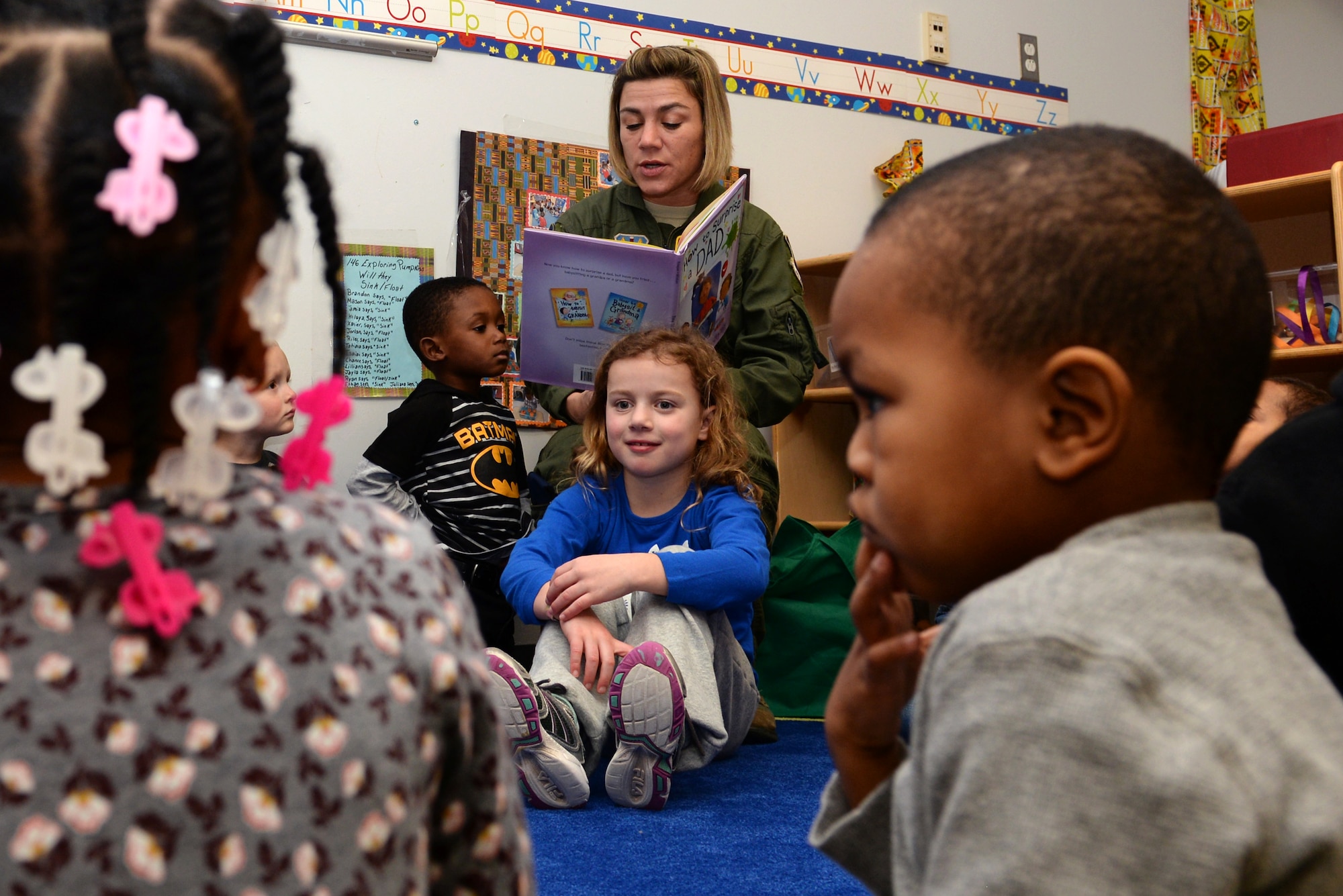 Tech. Sgt. Jennifer Kernan, an aerospace operational physiology technician with the 633rd Aerospace Medical Squadron, reads to the preschool children at the child development center at Langley Air Force Base, Va., Feb. 16, 2016. Kernan organizes The Mayor’s Book Club programs at Langley, which allows volunteers to reach out to preschool children and encourage a healthy habit for reading.  (U.S. Air Force photo by Airman 1st Class Kaylee Dubois)