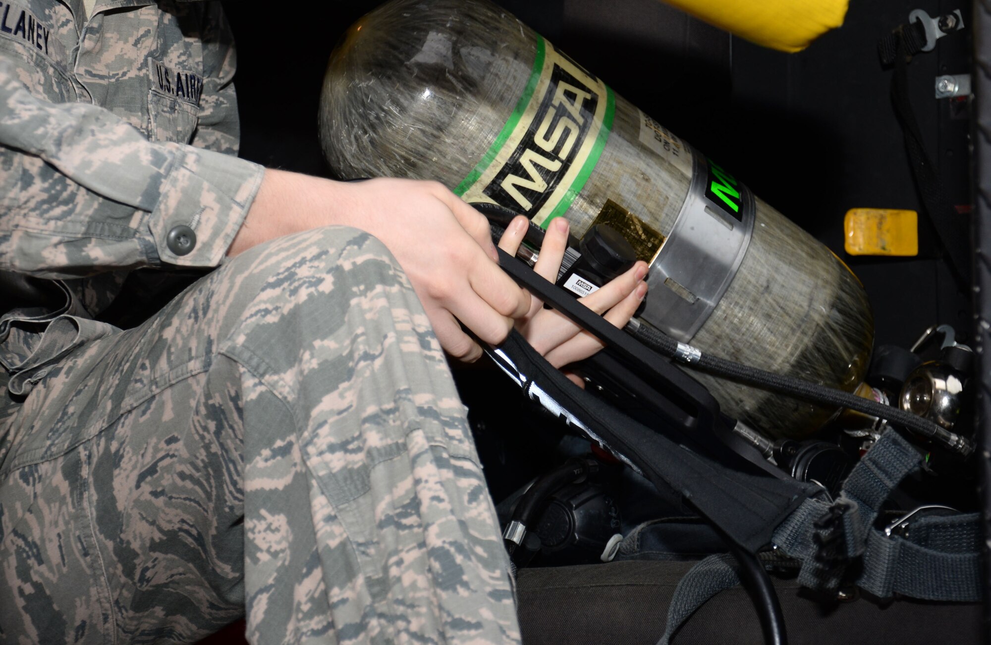 U.S. Air Force Senior Airman Conor Delaney, 100th Civil Engineer Squadron firefighter, checks his air pack tank Feb. 22, 2016, on RAF Mildenhall, England. A typical day begins at around 7:15 a.m. with gear check. At 7:30 a.m., a change over is conducted and roll call where one shift goes off and passes any information needed to the shift coming on.  (U.S. Air Force photo by Gina Randall/Released)