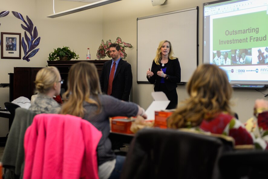 Rebecca Franciscus, Securities and Exchange Commission, and Matt Garth, Internal Revenue Service Special Agent, brief Team Schriever members on investment fraud as part of the Military Saves Week Wednesday, Feb. 24, 2016, at Schriever Air Force Base. Military Saves Week is an annual event, held in conjunction with America Saves, which helps service members and their families learn ways to save money. (U.S. Air Force photo/Christopher DeWitt)