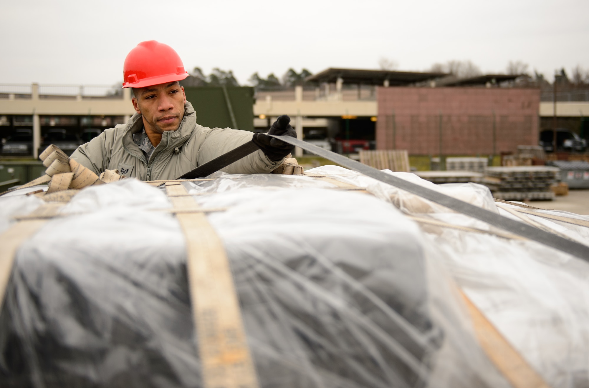 Staff Sgt. Jacques Cabrol, 1st Combat Communications Squadron tactical network supervisor, untangles a strap during the pre-loading phase in preparation for a communication mission at Ramstein Air Base, Germany, Feb. 17, 2015. Airmen from the 1st CBCS deploy to a variety of locations across Europe and Africa. This was the first time in since 2012 they prepared, drove and self-generated their own convoys. (U.S. Air Force photo/Staff Sgt. Armando A. Schwier-Morales)