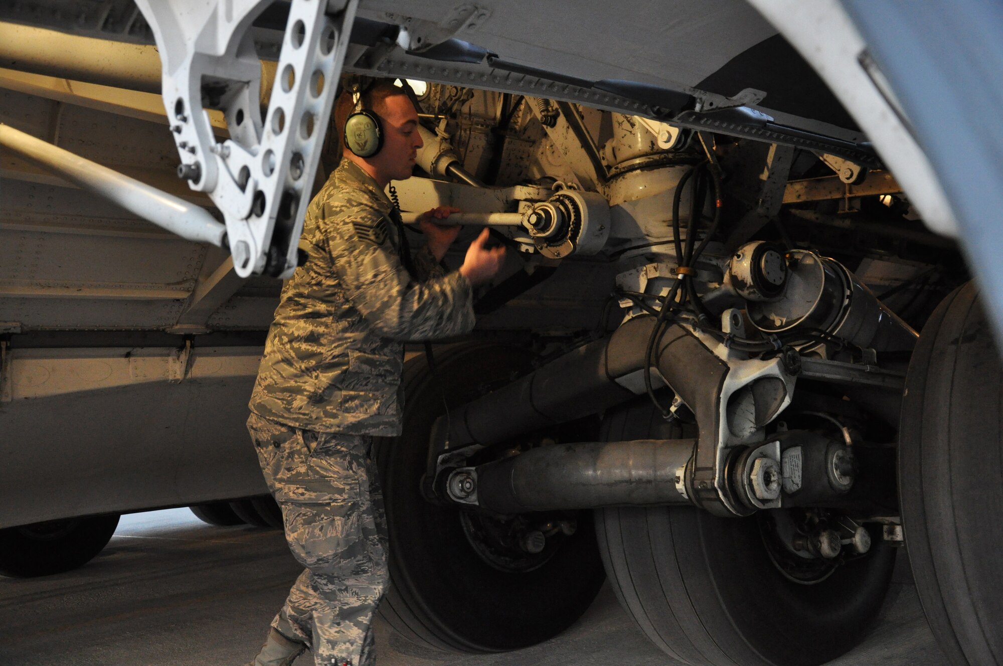Staff Sgt. Steven Sentner, 8th Expeditionary Air Mobility Squadron C-17 Globemaster III crew chief, from Irvine, Calif., inspects the landing gear of a C-17 at Al Udeid Air Base, Qatar, Feb. 19. The 8th EAMS maintenance team performs maintenance actions on C-17 aircraft to ensure they’re mission ready. (U.S. Air Force photo by Tech. Sgt. James Hodgman/Released)

