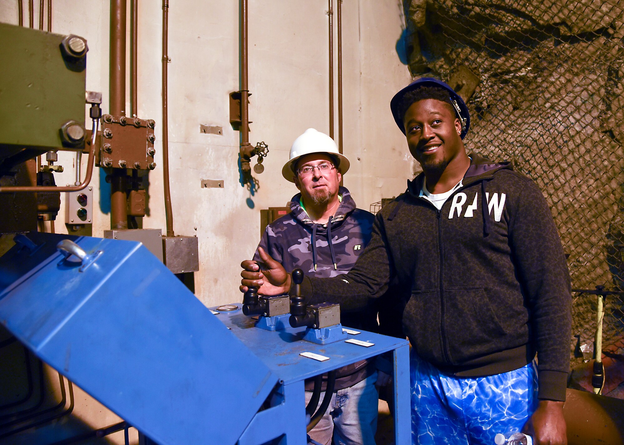 CHEYENNE MOUNTAIN AIR FORCE STATION - Steven Johnson (right), National Football League linebacker for the Tennessee Titans, opens a set of blast doors during a  visit and tour of Cheyenne Mountain Air Force Station on March 1, 2016. The visit and tour is part of the ongoing 50th Anniversary celebration for CMAFS. The installation was declared fully operational April 20, 1966. (U.S. Air Force photo by Tech. Sgt. Jared Marquis)