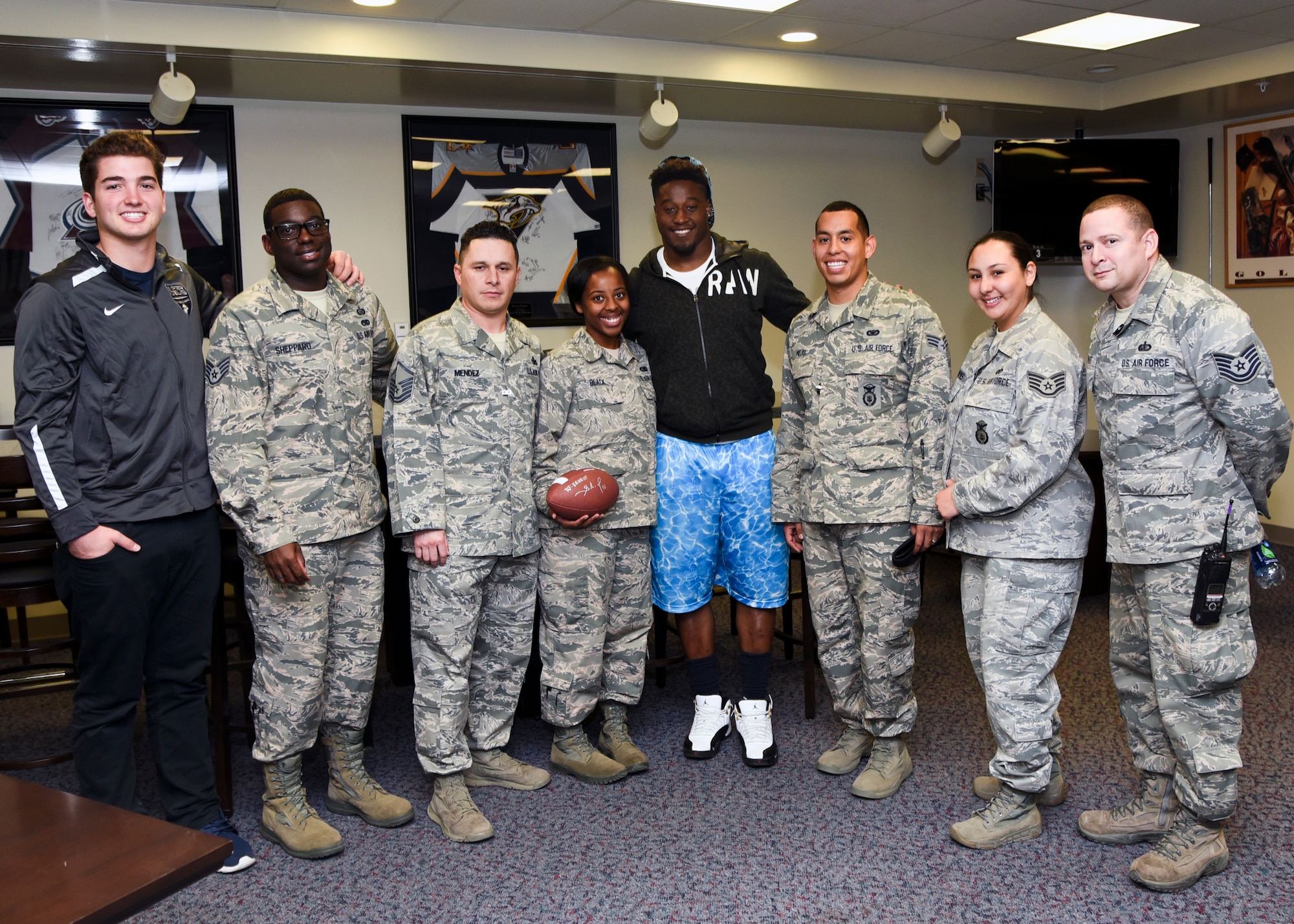 CHEYENNE MOUNTAIN AIR FORCE STATION - Steven Johnson (center), National Football League linebacker for the Tennessee Titans, and JoJo Domann (left), recent strong safety recruit to the University of Nebraska, signed autographs and posed for photos with Airmen assigned to CMAFS on March 1, 2016. The visit and tour is part of the ongoing 50th Anniversary celebration for CMAFS. The installation was declared fully operational April 20, 1966. (U.S. Air Force photo by Tech. Sgt. Jared Marquis)