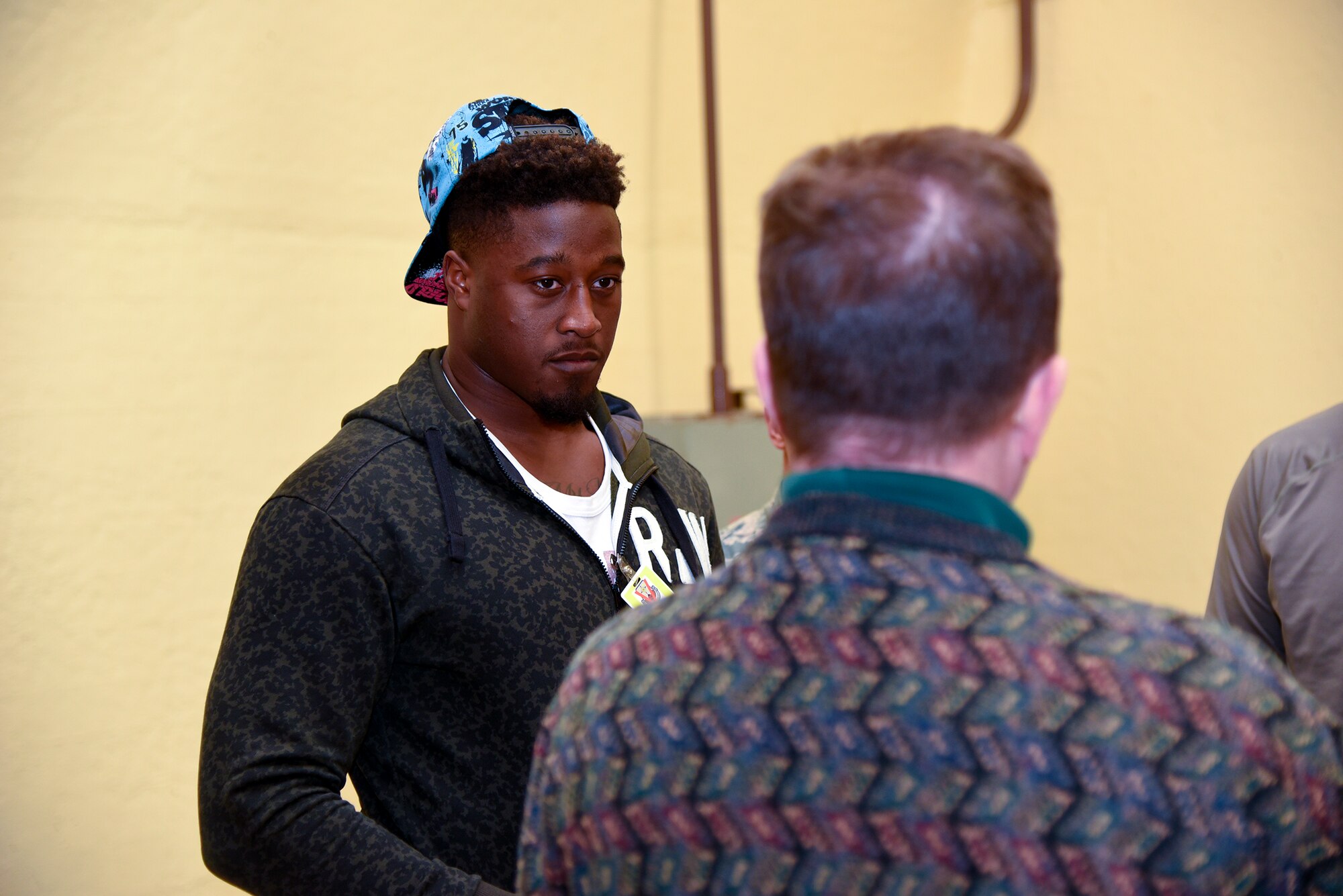 CHEYENNE MOUNTAIN AIR FORCE STATION - Steven Johnson, National Football League linebacker for the Tennessee Titans, receives a tour from Steven Rose, 721st Mission Support Group deputy director during a visit to Cheyenne Mountain Air Force Station on March 1, 2016. Johnson, his wife Stephanie, and JoJo Domann, recent strong safety recruit to the University of Nebraska, along with his father and brother took part in the tour. The visit and tour is part of the ongoing 50th Anniversary celebration for CMAFS. The installation was declared fully operational April 20, 1966. (U.S. Air Force photo by Tech. Sgt. Jared Marquis)