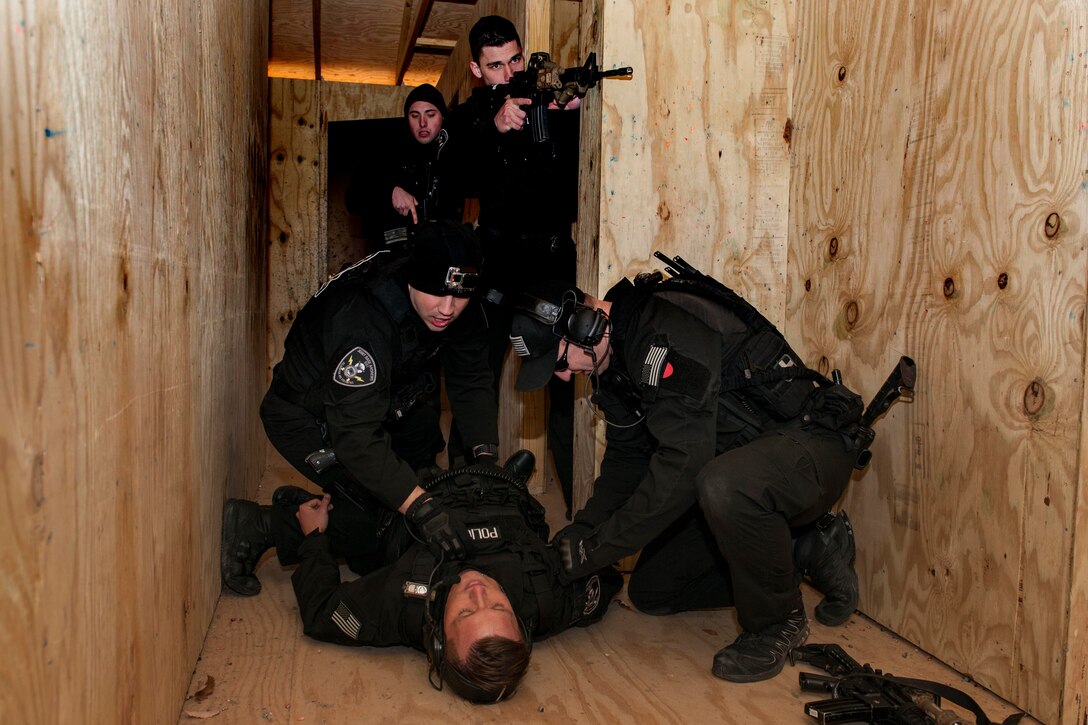 Members of the 11th Security Forces Emergency Service team, provide aid to a simulated wounded team member during a training scenario during a Combat Life Saver class, at Joint Base Andrews, Md., Feb. 26, 2016. More than 15 Security Forces Airmen took part in an all-day training class that provides them the tools to render care in the field under fire or in combat. (U.S. Air Force Senior Airman Dylan Nuckolls/Released)