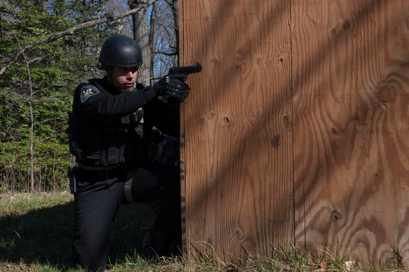 Staff Sgt. Gabriell Vieira, 811th Security Forces Squadron raven team leader, provides cover during a training scenario during a Combat Life Saver class, at Joint Base Andrews, Md., Feb. 26, 2016. More than 15 Security Forces Airmen took part in an all-day training class that provides them the tools to render care in the field under fire or in combat. (U.S. Air Force Senior Airman Dylan Nuckolls/Released)