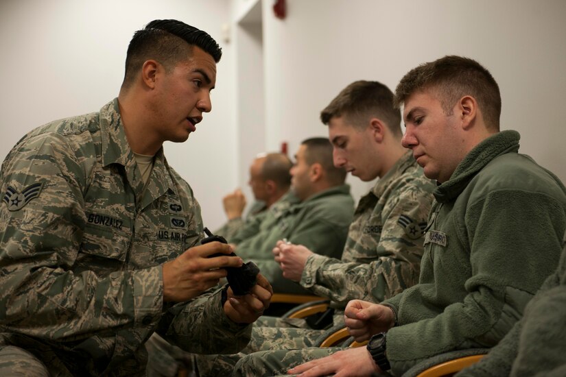 Senior Airman Adam Gonzalez, 11th Security Forces Emergency Service team medic, left, reviews a Security Forces member’s tourniquet during a Combat Life Saver class, at Joint Base Andrews, Md., Feb. 26, 2016. More than 15 Security Forces Airmen took part in an all-day training class that provides them the tools to render care in the field under fire or in combat. (U.S. Air Force Senior Airman Dylan Nuckolls/Released)