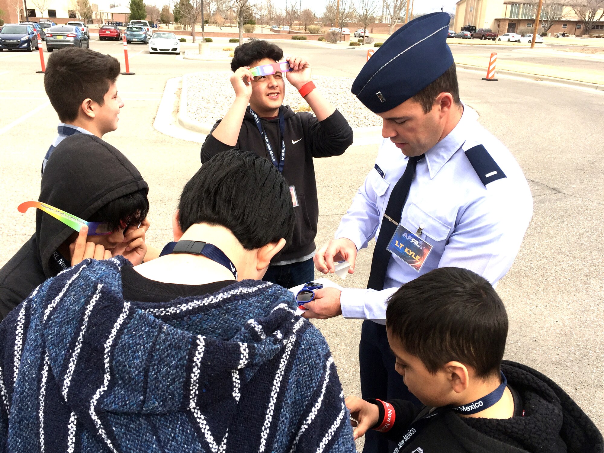 Students from Garfield Middle School in Albuquerque watch as Air Force Research Laboratory New Mexico's 1st Lt. Kyle Ziegler demonstrates how the lab uses Science, Technology, Engineering and Mathematics in their mission of research and development March 1 here. The visit was part of the Day at the Lab event hosted by AFRL. National laboratories across the US are holding similar events as part of a White House initiative to encourage more children to become involved in STEM and to show the exciting and diverse workplace the national laboratories provide. Ziegler, who is the program manager for Space Electrical Technology at AFRL, took students through experiments and demonstrations of scientific phenomena that scientists and engineers encounter in the course of their work at AFRL. Students, which included groups from Wilson Middle School, also saw exhibits and demonstrations in microwave energy, the Cold Atoms Lab, MAX POWER, a vehicle using microwaves to safely destroy improvised explosive devices, and the Roll-Out Solar Array. (Air Force photo by Jim Fisher)  