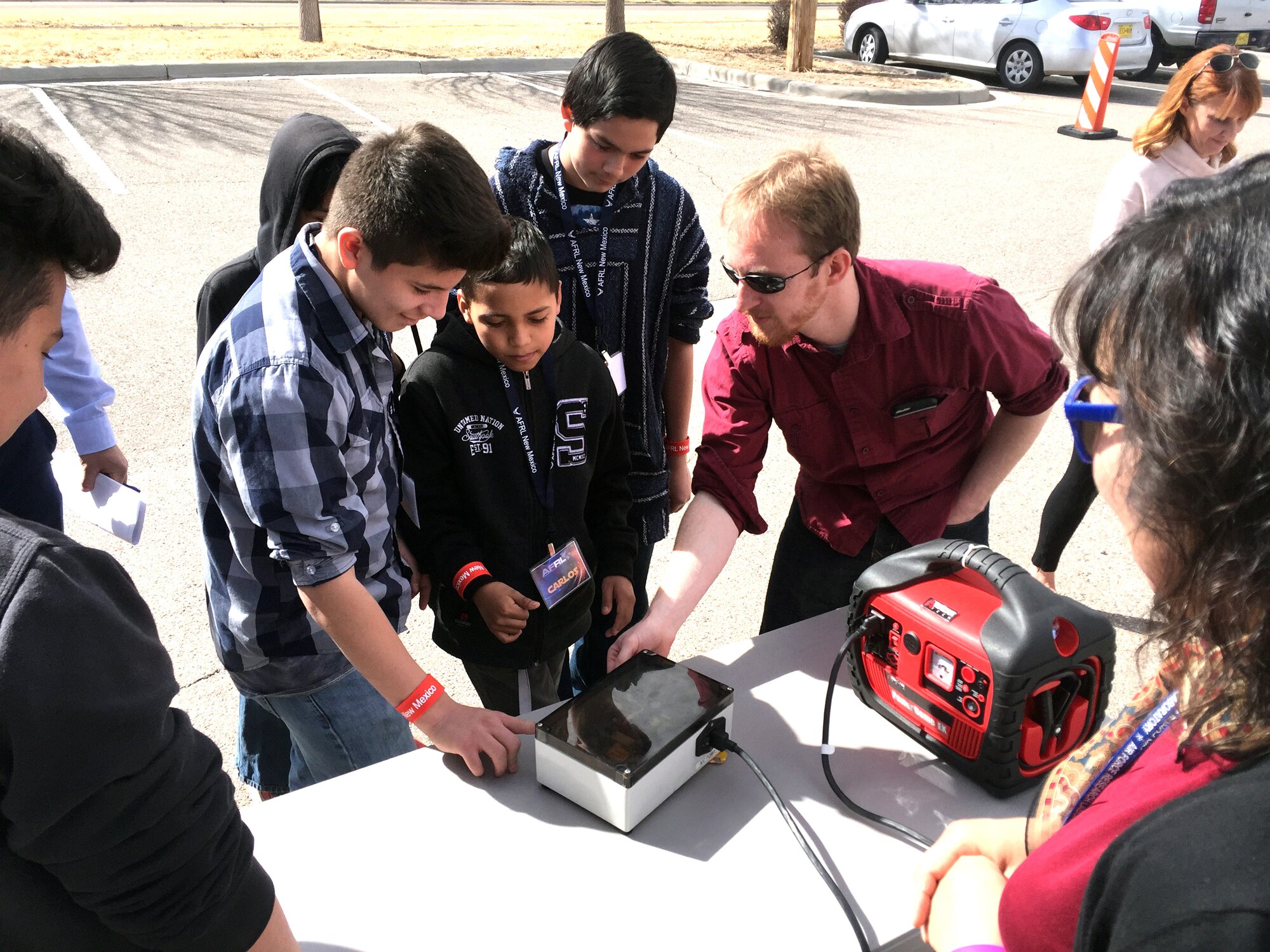 Students from Garfield Middle School in Albuquerque watch as Air Force Research Laboratory New Mexico's Daniel Guillette demonstrates how the lab uses Science, Technology, Engineering and Mathematics in their mission of research and development March 1 here. The visit was part of the Day at the Lab event hosted by AFRL. National laboratories across the US are holding similar events as part of a White House initiative to encourage more children to become involved in STEM and to show the exciting and diverse workplace the national laboratories provide. Guillette, who is an electrical engineer at AFRL, took students through experiments and demonstrations of scientific phenomena that scientists and engineers encounter in the course of their work at AFRL. Students, which also included groups from Wilson Middle School, also saw exhibits and demonstrations in microwave energy, the Cold Atoms Lab, MAX POWER, a vehicle using microwaves to safely destroy improvised explosive devices, and the Roll-Out Solar Array. (Air Force photo by Jim Fisher)  