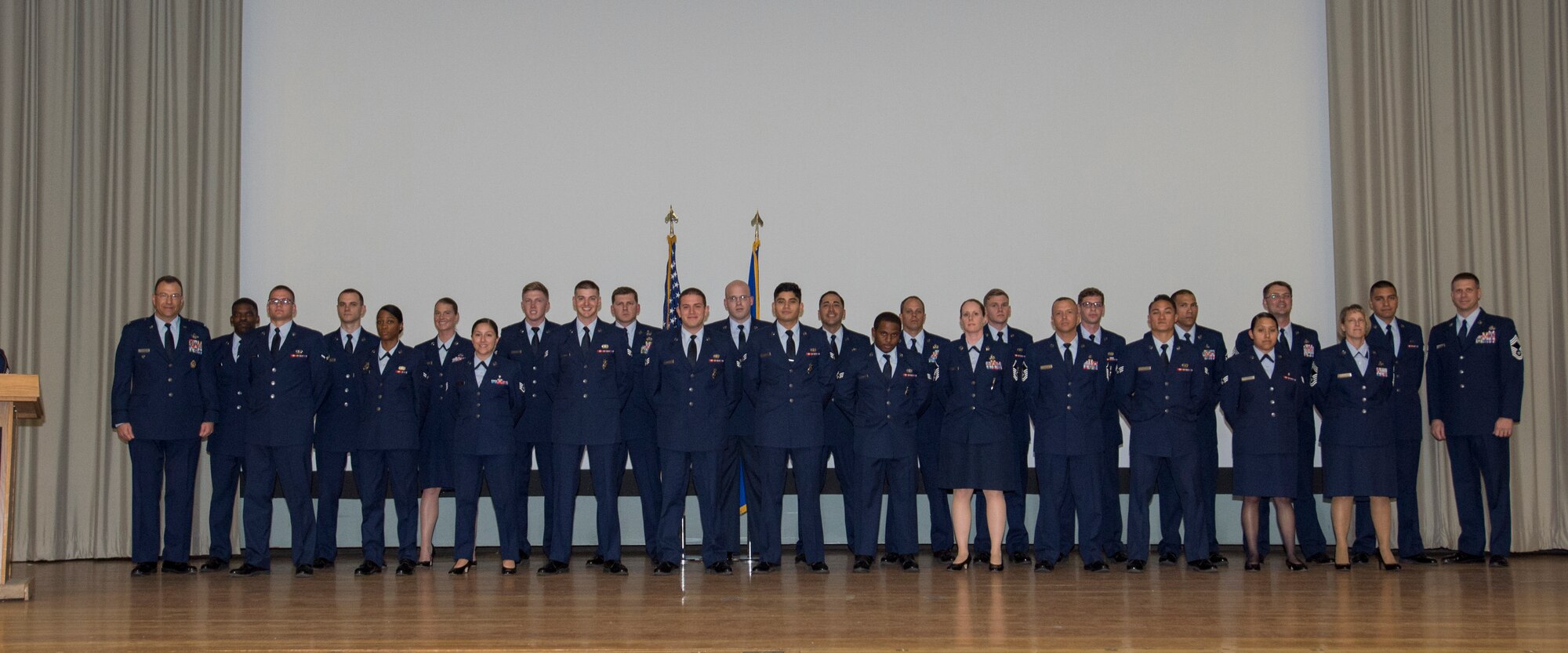 Airmen pose for a group photo following the monthly enlisted promotion ceremony held at the base theater Feb. 29. (U.S. Air Force photo by Joseph Gocong)