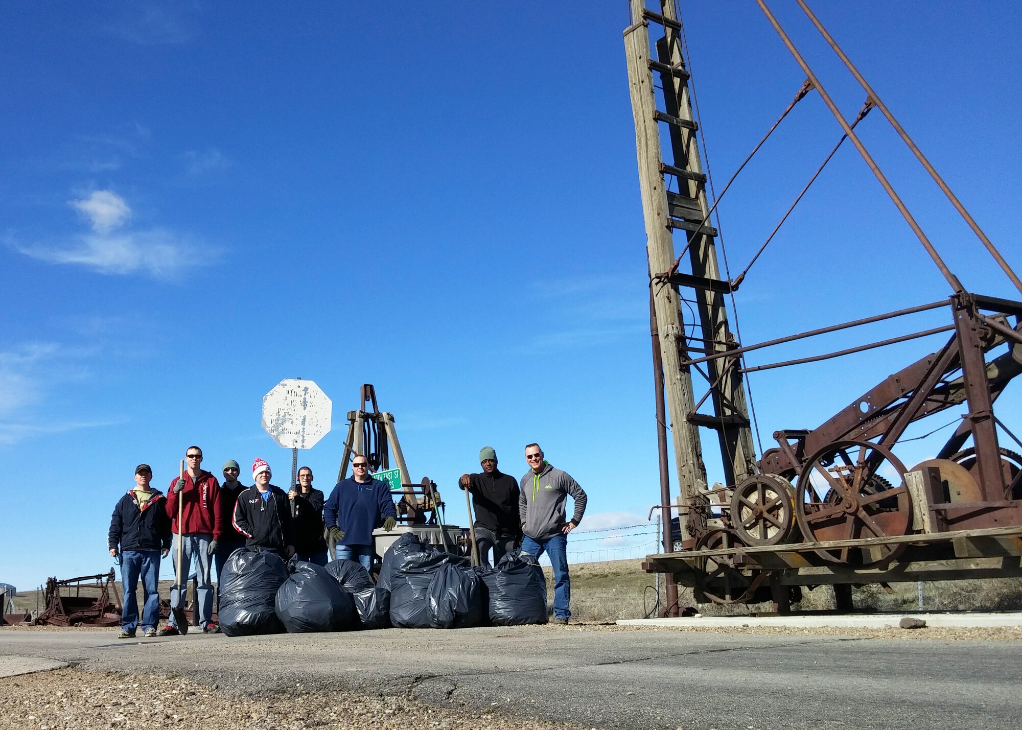 Airmen from the 31st Test and Evaluation Squadron and Air Force Operational Test and Evaluation Center Detachment 1 pose for a group photo after volunteering to pick up trash along a 1.6 mile piece of land outside Mountain Home Air Force Base, Idaho. (Courtesy photo)