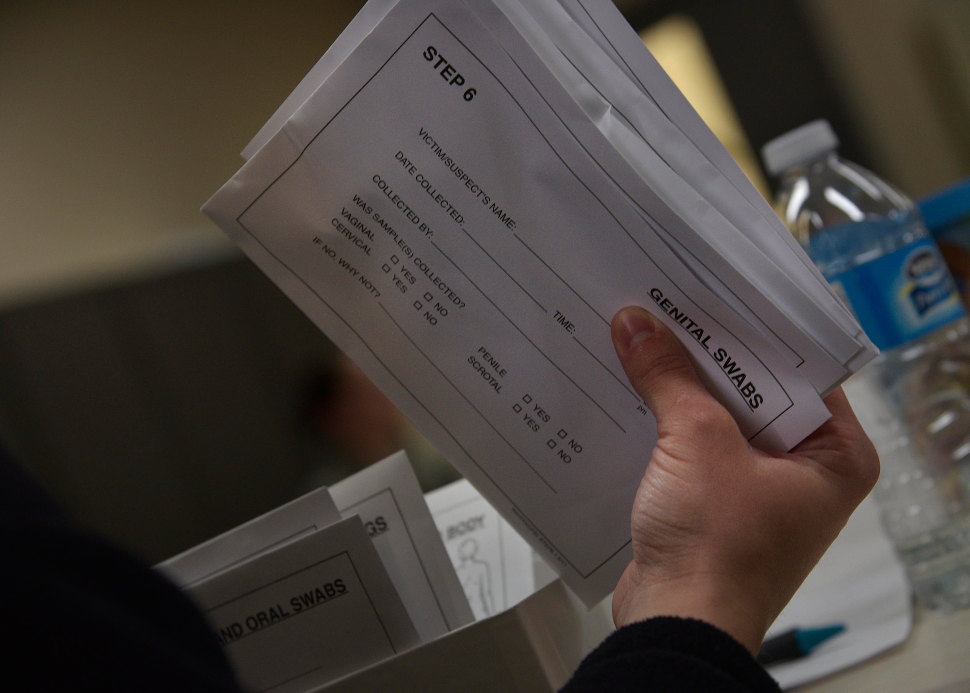A Sailor assigned to the Naval Air Facility Misawa looks at a medical kit used to gain DNA samples after a sexual assault during the victim advocates training at Misawa Air Base, Japan, Feb. 25, 2016. Representatives from the 35th Medical Group and the legal office performed demonstrations to the 19 Sailors and Airmen in attendance, helping them understand the process after a sexual assault is reported.  (U.S. Air Force photo by Senior Airman Deana Heitzman)