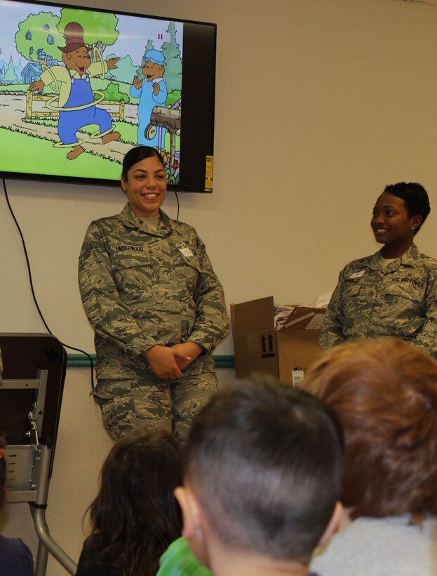 579th Dental Squadron's dental assistants Senior Airman Sade Underwood and Senior Airman Danielle Quarles talk to CDC 1 preschoolers about the importance of good oral habits, eating healthy snacks and visiting the dentist regularly. (U.S. Navy photo by Tamara Ward)