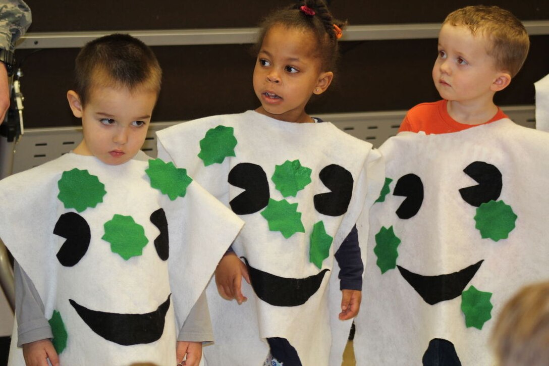Preschoolers Juan Andreli, Sydney Whitaker and Noah Langis dressed up as teeth waiting to be cleaned during the 579th Dental Squadron presentation in observance of National Children’s Dental Health Month at CDC 1 on Joint Base Anacostia-Bolling in  Feb. (U.S. Navy photo by Tamara Ward)