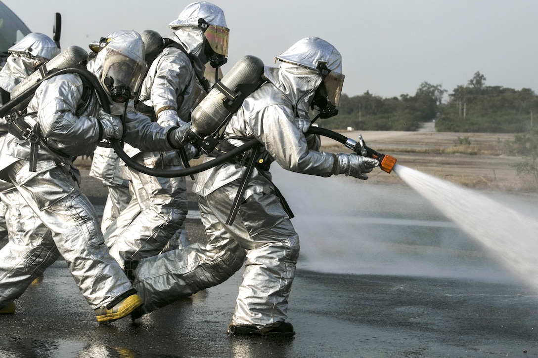 A group of Marines spray fuel away from them during an aircraft fire training exercise as part of Cobra Gold 16 in Utapao, Thailand, Feb. 19, 2016. Cobra Gold is a multi-national exercise designed to increase interoperability and relations between participating nations in the Asia-Pacific region. The Marines are with Marine Wing Support Squadron 172, Marine Aircraft Group 36, 1st Marine Aircraft Wing, III Marine Expeditionary Force. Marine Corps photo by Cpl. William Hester