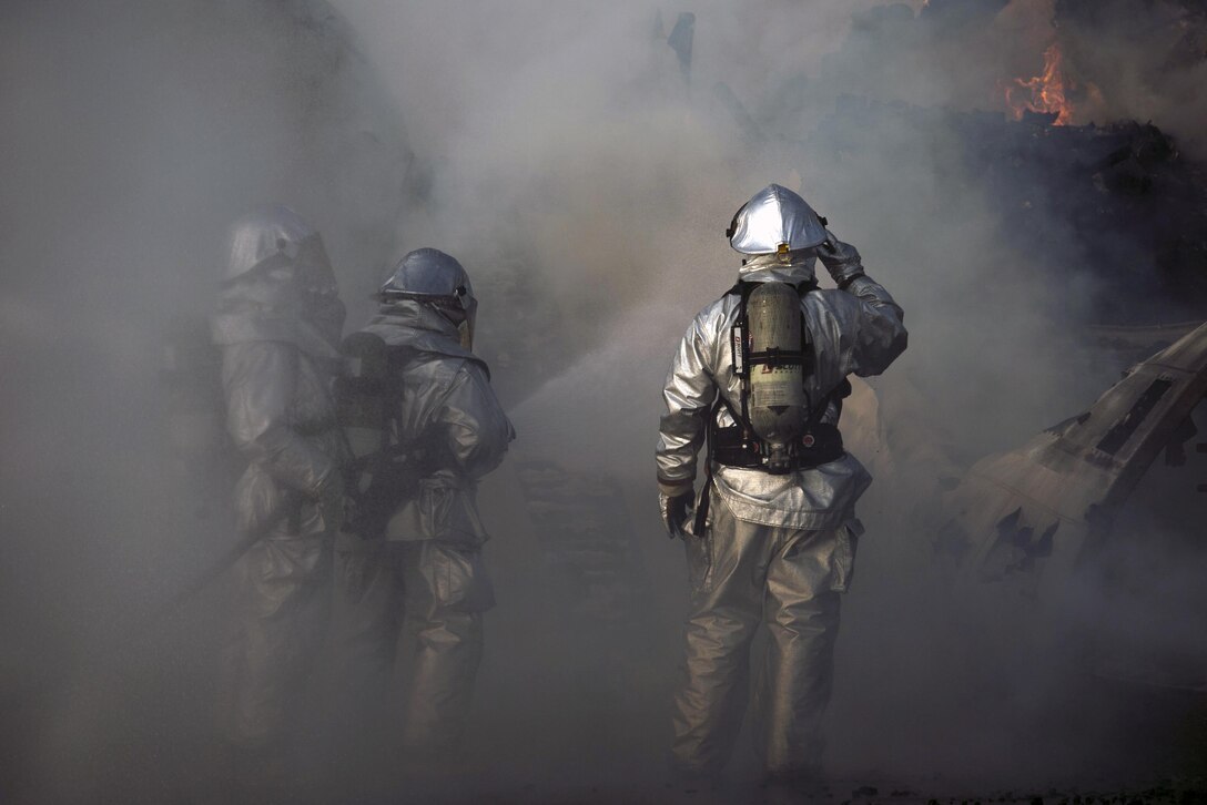 Marines put out the last few fires on an engulfed aircraft during  Cobra Gold 16 in Utapao, Thailand, Feb. 19, 2016. Cobra Gold is a multinational exercise designed to increase cooperation and interoperability between participating nations in the Asia-Pacific region. The Marines are assigned to Marine Wing Support Squadron 172, Marine Aircraft Group 36, 1st Marines Aircraft Wing, 3rd Marine Expeditionary Force. Marine Corps photo by Cpl. William Hester