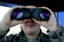 U.S. Air Force Senior Airman Joseph Shaffner, 8th Operations Support Squadron air traffic control journeyman, scans the flight line at Kunsan Air Base, Republic of Korea, Feb. 24, 2016. The air traffic control tower oversees the base's entire flight line and its height allows air traffic controllers to see aircraft flying within the base's immediate air space. (U.S. Air Force photo by Senior Airman Ashley L. Gardner/Released)
