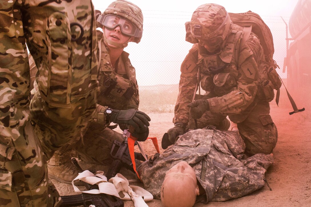Army Capt. Caitlyn Rerucha, left, and Army Cpl. Steven Upham treat a simulated patient at a tactical combat casualty care lane at Camp Buehring, Kuwait, Feb. 23, 2016. Rerucha is assigned to the 10th Combat Support Hospital and Upham is a medic assigned to Company B, 1st Battalion, 63rd Armor Regiment. Army photo by Staff Sgt. Ian M. Kummer