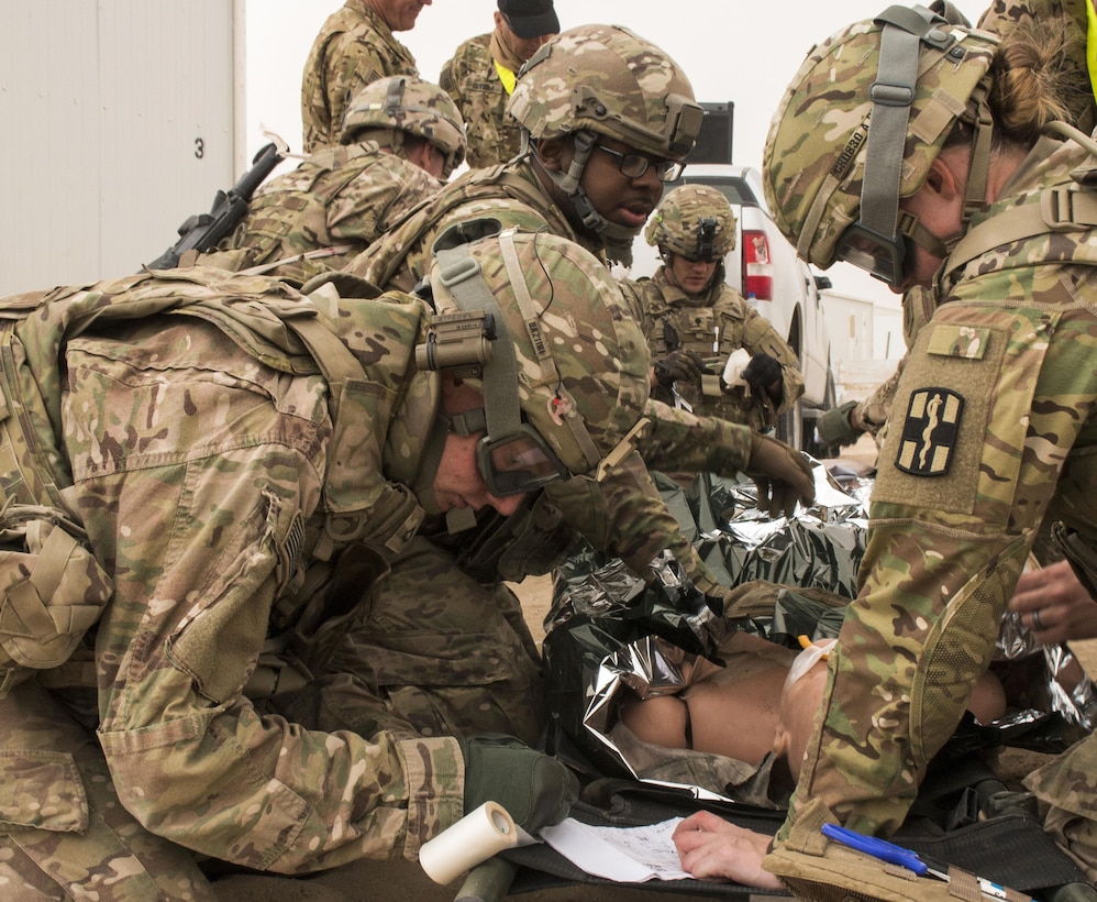 Soldiers treat simulated patients at a tactical combat casualty care lane at Camp Buehring, Kuwait, Feb. 23, 2016. Army photo by Staff Sgt. Ian M. Kummer