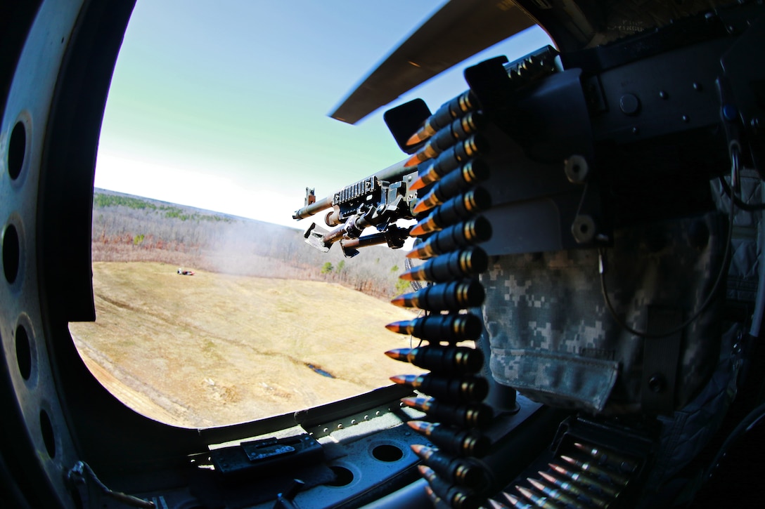 A soldier fires a M-240H machine gun at targets during an aerial gunnery exercise on Fort Pickett, Va., Feb. 28, 2016. The soldier is assigned to the 82nd Airborne Division’s 3rd General Support Aviation Battalion, 82nd Combat Aviation Brigade. Army photo by Staff Sgt. Christopher Freeman