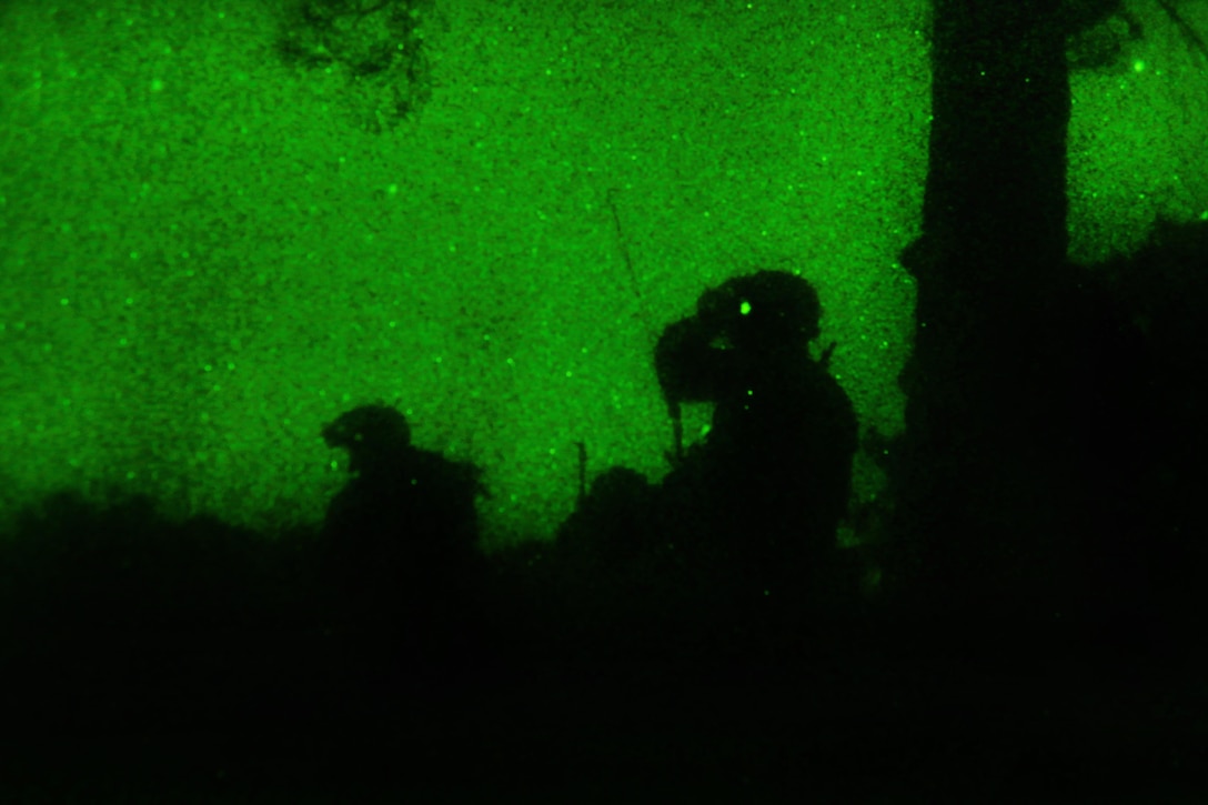 As seen through a night-vision device, a paratrooper makes adjustments to his night vision goggles during an air assault exercise on Fort Pickett, Va., Feb. 29, 2016. Army photo by Staff Sgt. Christopher Freeman