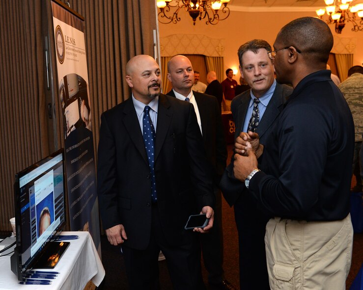 Law enforcement agents speak with a patron at the 4th annual technology expo at Barksdale Air Force Base, La., Feb. 25, 2016. The agents spoke about advances in a network used by law enforcement agencies to share vital information in effectively detecting and detaining criminals. (U.S. Air Force photo/Airman 1st Class Curt Beach)