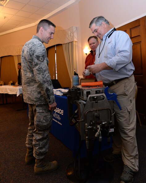 Staff Sgt. Jason Degering, 2nd Communications Squadron cable maintenance, speaks with Rich Browing, sales representative, at the 4th Annual Technology Expo Barksdale Air Force Base, La., Feb. 25, 2016. Browing shared his company’s latest innovations, including a flexible, multi-celled fabric inner duct solution for underground cable installations. (U.S. Air Force photo/Airman 1st Class Curt Beach)