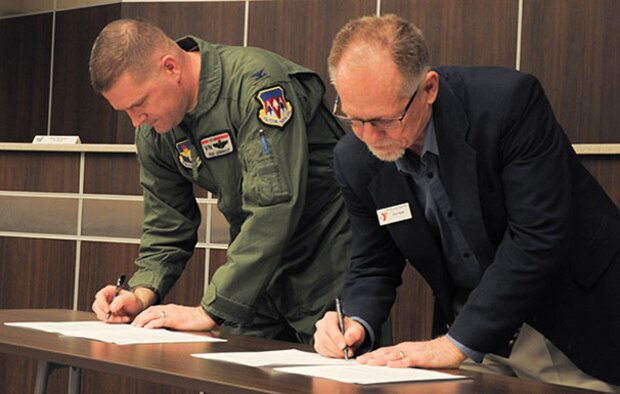 Col. Fred Cunningham, left, 71st Flying Training Wing vice commander, and Ken Rapp, head of the Denny Price Family YMCA of Enid, Oklahoma, formalized an agreement that will let Vance Air Force Base Airmen use the YMCA’s indoor track for PT testing, during the Feb. 29 meeting of the newly formed Air Force Community Partnership program. (U.S. Air Force photo/ 2nd Lt. Hailey Schroeder)