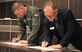 Col. Fred Cunningham, left, 71st Flying Training Wing vice commander, and Ken Rapp, head of the Denny Price Family YMCA of Enid, Oklahoma, formalized an agreement that will let Vance Air Force Base Airmen use the YMCA’s indoor track for PT testing, during the Feb. 29 meeting of the newly formed Air Force Community Partnership program. (U.S. Air Force photo/ 2nd Lt. Hailey Schroeder)