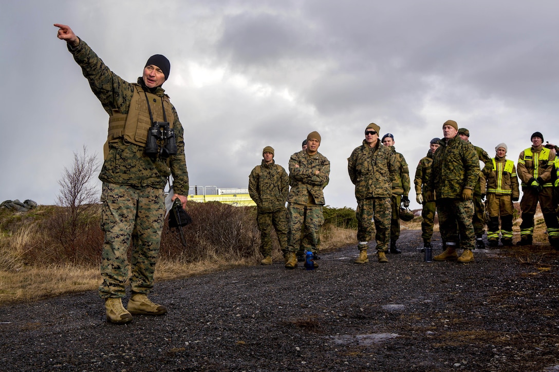 A U.S. Marine points in the direction that fellow Marines and Norwegian soldiers will fire FIM-92C Stinger missiles as a part of Exercise Cold Response 16 at Orland, Norway, Feb. 24, 2016, 2016. Marine Corps photo by Cpl. Rebecca Floto