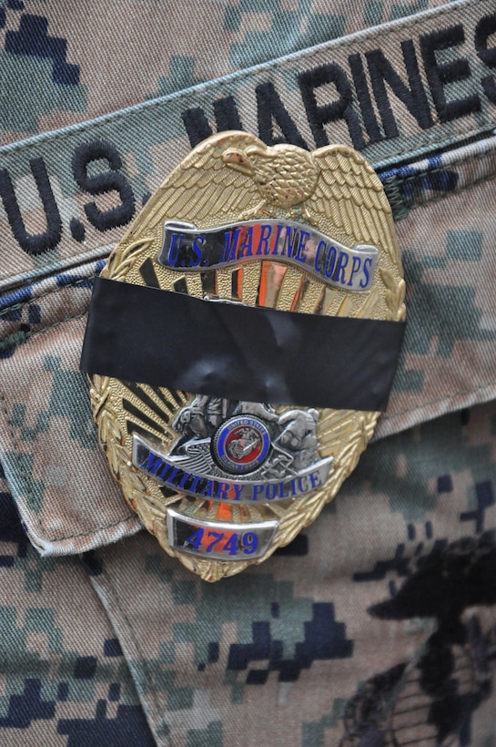 Marine Corps Base Quantico Military Police display the traditional symbol of mourning when a fellow officer has fallen.

Mourning Band: Quantico Honors Marine Reservist, Prince William County Police Officer Ashley M. Guindon, who was Gunned Down in the Line of Duty, Feb. 27.