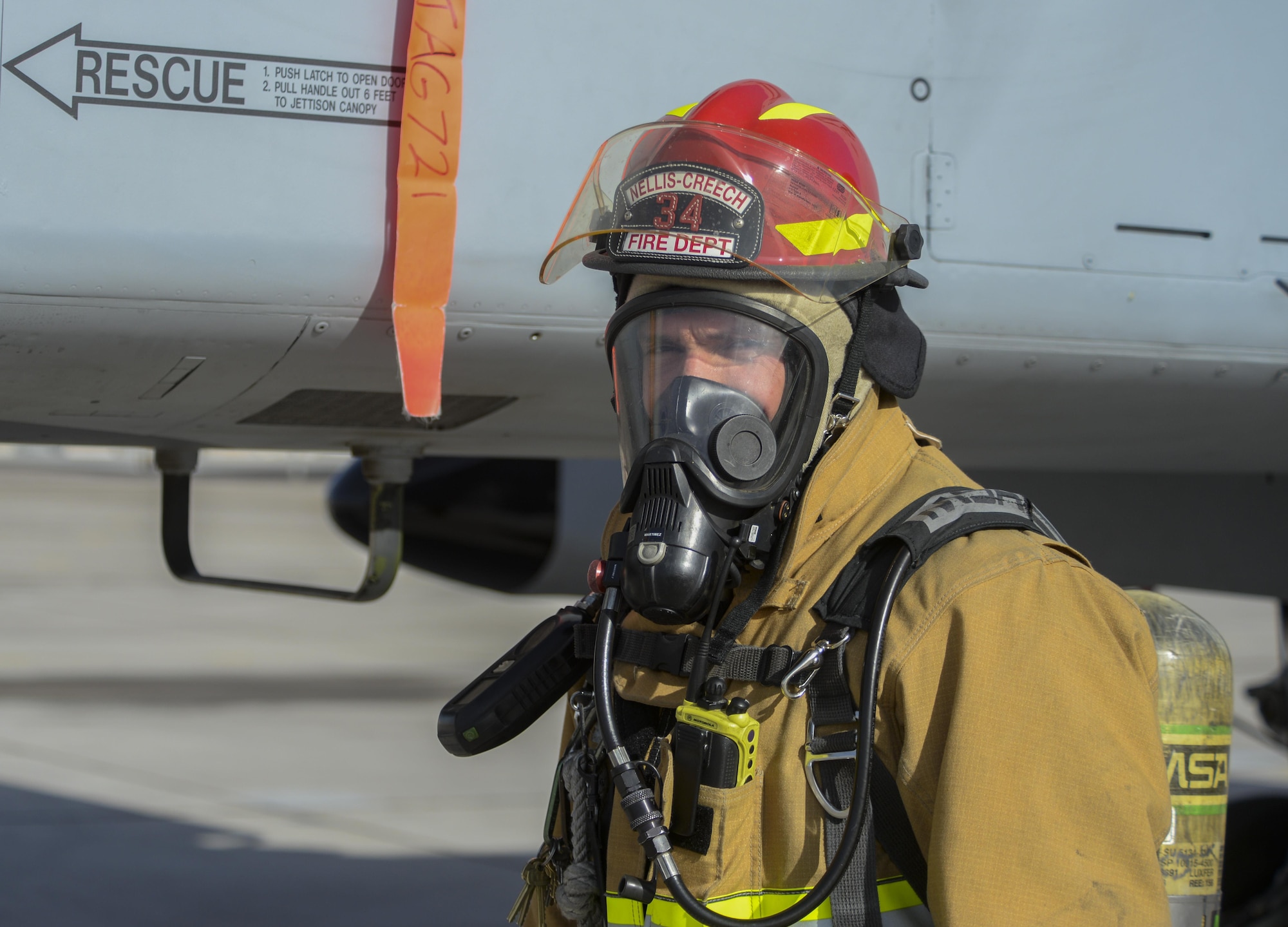 Fire Capt. Jason Martinez, 99th Civil Engineer Squadron lead firefighter, finishes chalking an aircraft on the flight line at Nellis Air Force Base, Nev., March 1, 2016. The 99th CES Fire Protection Flight won the Air Force Fire Department of the Year Award for 2015. The award takes into account all aspects of the fire department including the management team, operations, training and fire prevention section. (U.S. Air Force photo by Airman 1st Class Nathan Byrnes)