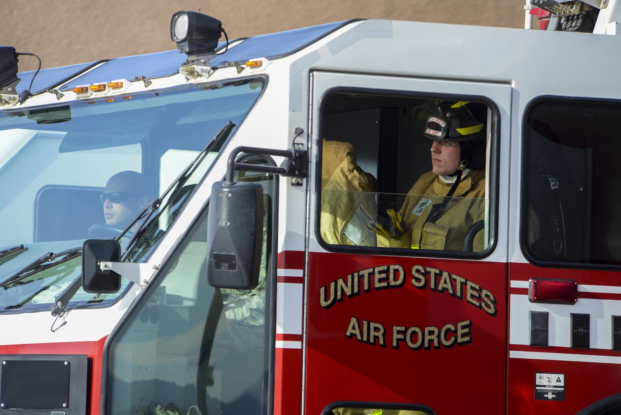 Airman 1st Class Ethan Quetin, 99th Civil Engineer Squadron firefighter, sits in the fire engine before morning inspections at Nellis Air Force Base, Nev., March 1, 2016. The men and women of the 99th CES Fire Protection Flight are charged with keeping the Nellis and Creech AFB communities safe, protecting aircraft operations, building and wildland fire response, hazardous materials emergencies and medical response and were recognized for the work they did during 2015.