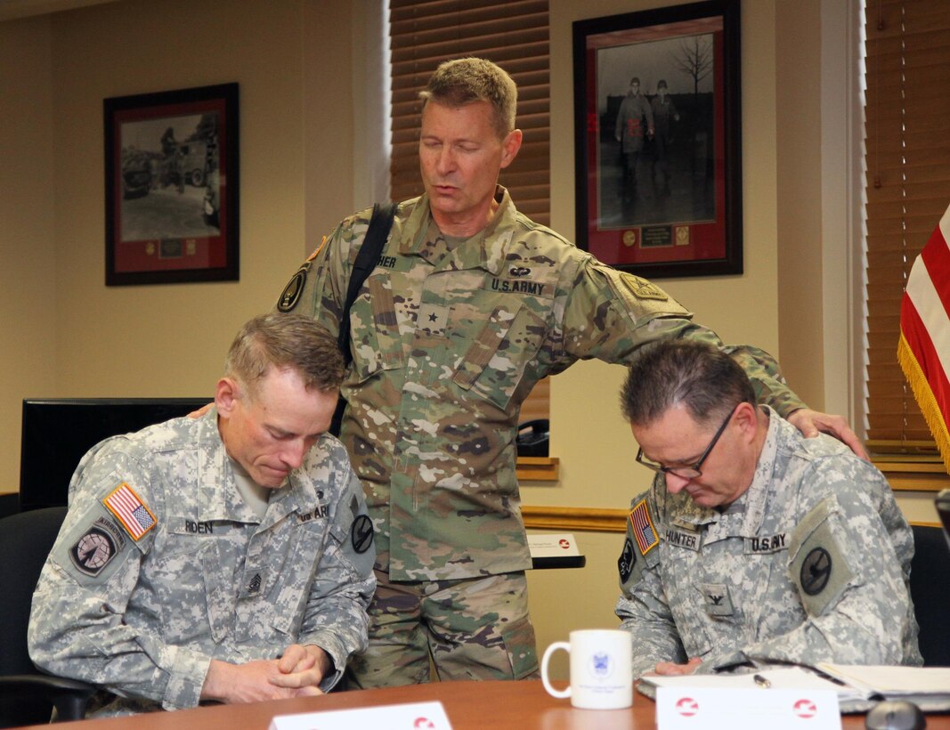 U.S. Army Brig Gen. Carlton Fisher, deputy chief of chaplains, U.S. Army Reserve, leads a group prayer with Sgt. Maj. Dwayne Riden and Col. David Hunter, chaplain, as part of the 84th Training Command Unit Ministry Team's Workshop at the Command headquarters on Fort Knox, Ky., Feb. 17, 2016. Riden is the command's chief chaplain assistant and Hunter is the command's chaplain. (U.S. Army Photo by Clinton Wood/Released)