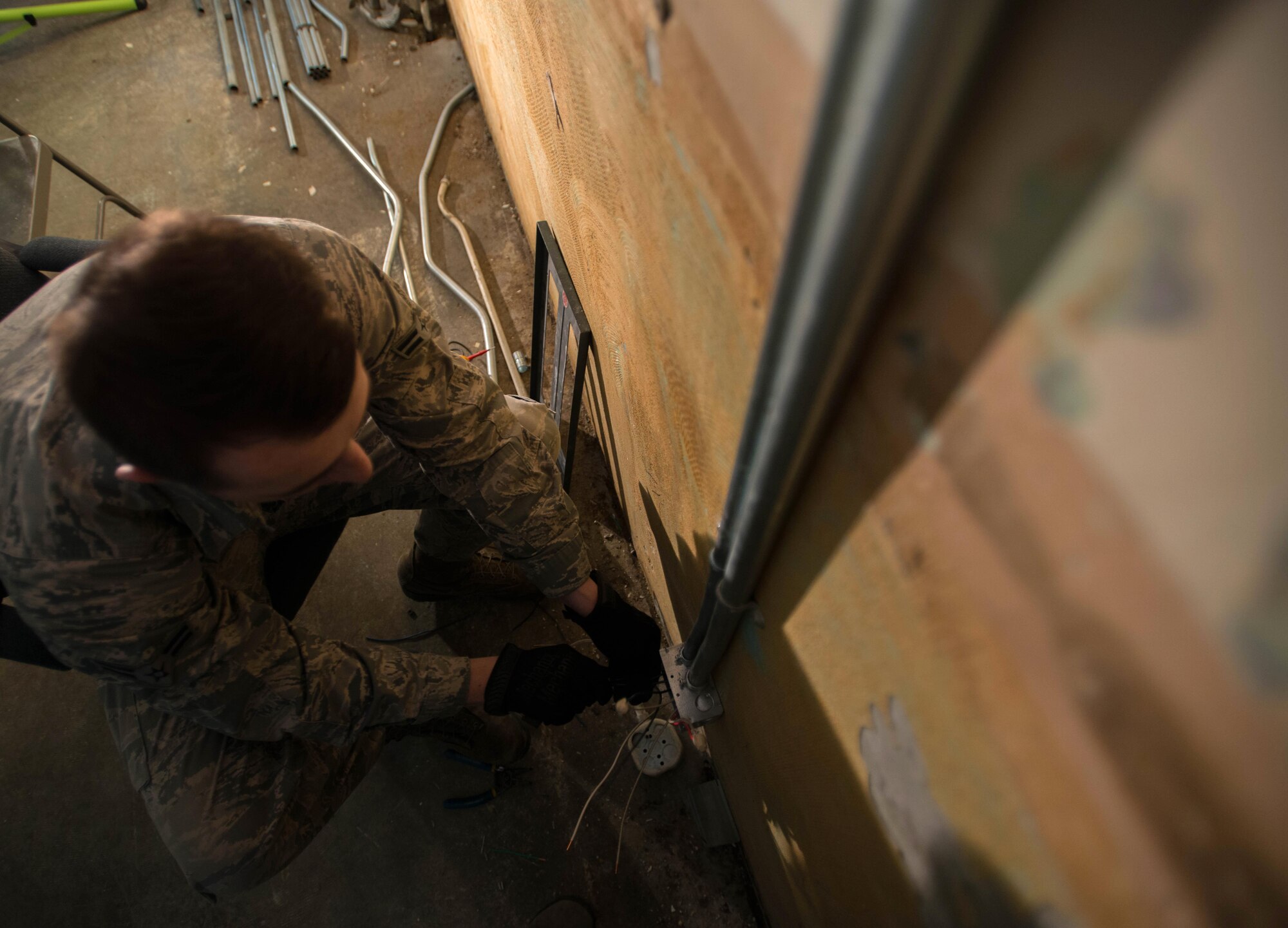 Electrical metallic conduit installed by Airman 1st Class Joshua Sprinkles, a 354th Civil Engineer Squadron electrical technician, leads to a junction box where wires are roughed in awaiting future construction in Amber Hall on March 3, 2016, at Eielson Air Force Base, Alaska. Preparing for an influx of Airmen in anticipation of the proposed future basing of the F-35 Lightening II at Eielson, the 354th CES and contractors are remodeling offices to support missions across the U.S. Pacific Air Forces area of responsibility. (U.S. Air Force photo by Staff Sgt. Shawn Nickel/Released) 