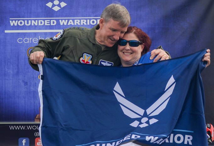 Gen. Hawk Carlisle, commander of Air Combat Command, hugs Air Force team competitor Lee Kuxhaus after being awarded a first place medal during the 2016 Air Force Wounded Warrior Trials at Nellis Air Force Base, Nev., March 1, 2016. More than 100 wounded, ill or injured Service Members from around the country compete for a spot on the 2016 Warrior Games Team which will represent the Air Force at the U.S. Military Academy at West Point in June. (U.S. Air Force photo by Airman 1st Class Kevin Tanenbaum)