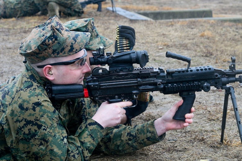 Marines with Headquarters and Service Battalion fire the M249 light machine gun.