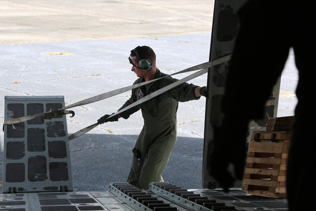 Staff Sgt. Staff Sgt. Jeremiah Gaulitz secures a ramp on a KC-130J Super Hercules during cargo transportation for exercise Eager Response at Marine Corps Air Station Cherry Point, N.C., Feb. 24, 2016.  During the exercise, Marines trained in events such as casualty evacuation, assault support missions and aerial refueling, proving the 2nd Marine Aircraft Wing is a highly effective combat force. Gaulitz is a crew master with VMGR-252. (U.S. Marine Corps photo by Cpl. N.W. Huertas/ Released) 