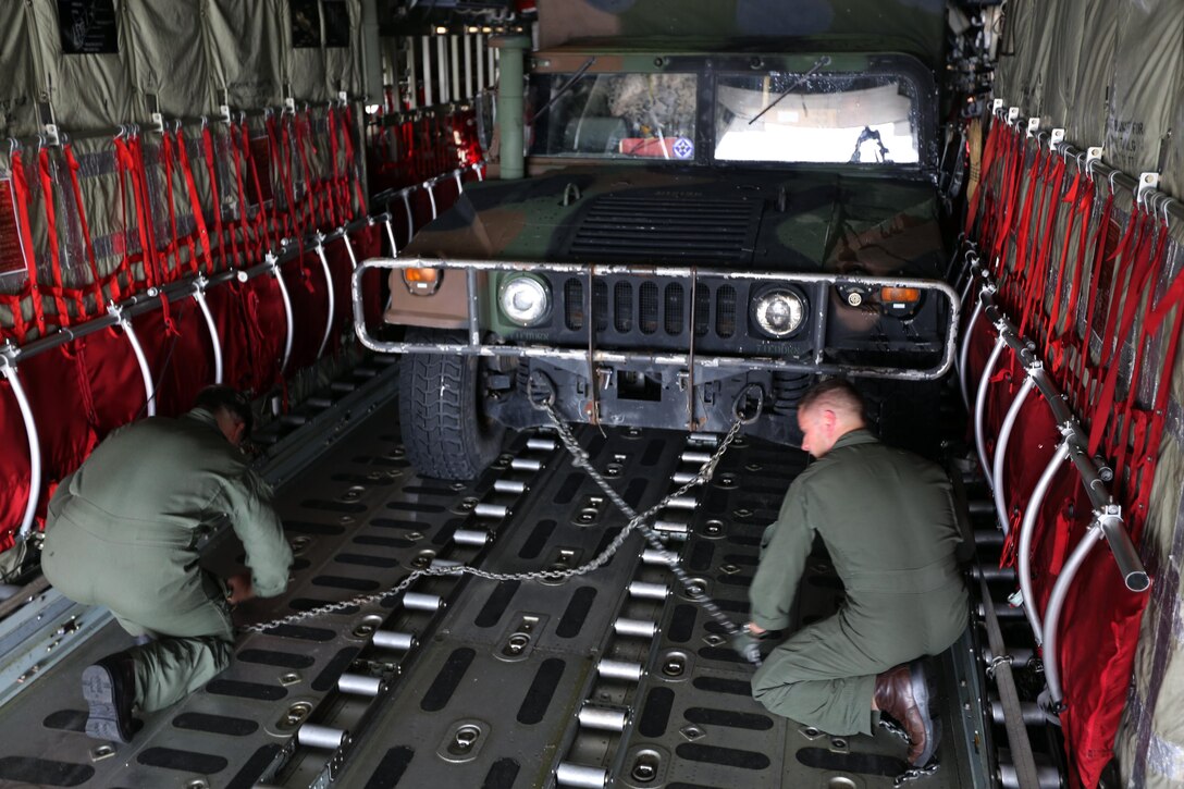 Marines secure a Humvee inside a KC-130J Super Hercules during a cargo transportation for exercise Eager Response at Marine Corps Air Station Cherry Point, N.C., Feb. 24, 2016.  During the exercise, Marines trained in events such as casualty evacuation, assault support missions and aerial refueling, proving the 2nd Marine Aircraft Wing is a highly effective combat force. (U.S. Marine Corps photo by Cpl. N.W. Huertas/ Released)